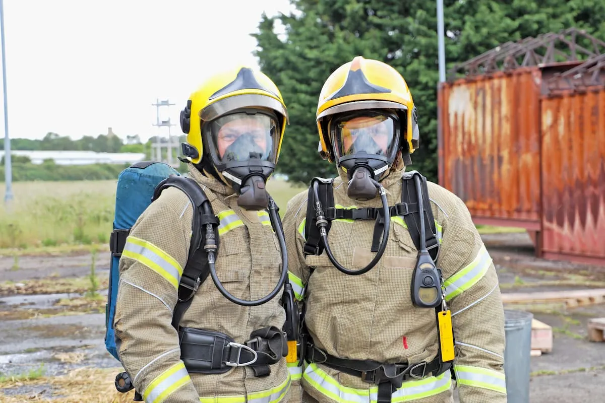 Two women fire fighter with full breathing apparatus